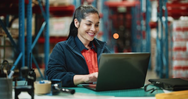 A worker accesses a self-service portal on her laptop to check on the status of her leave request.