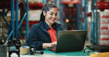 A worker accesses a self-service portal on her laptop to check on the status of her leave request.