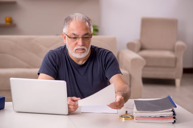Working while on leave of absence: senior man reading a document