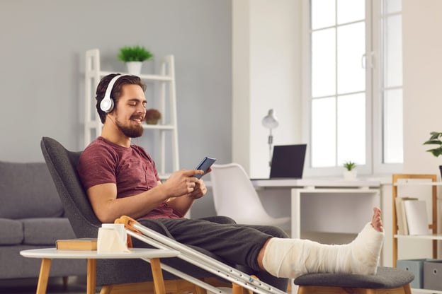 Injured man using his phone