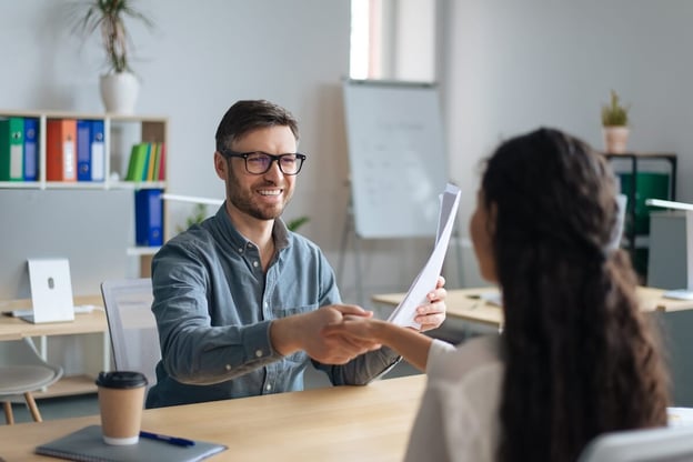 HR manager shaking hands with an employee