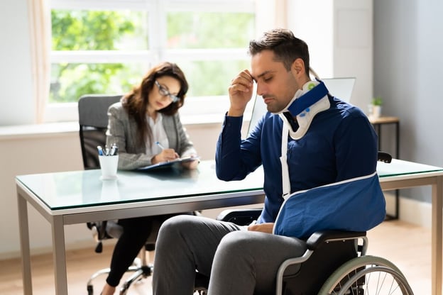 Employers liability insurance vs workers compensation: injured employee sitting in a wheelchair
