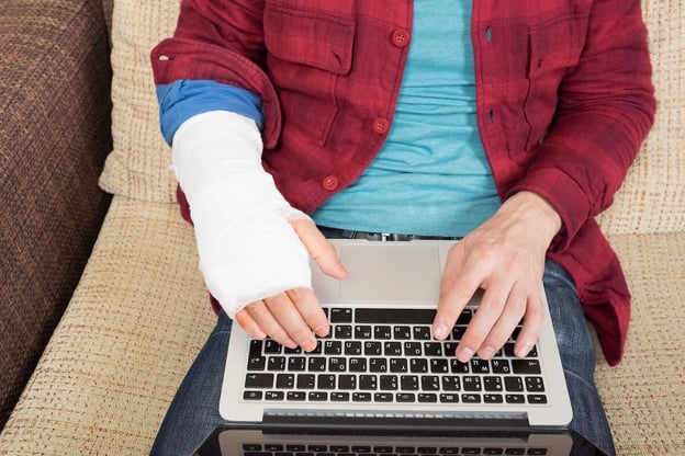 Injured person using a laptop