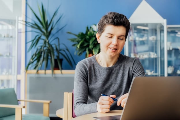 Entrepreneur holding a pen while reading something