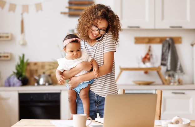 Personal leave of absence policy: mother talking on the phone while carrying her baby