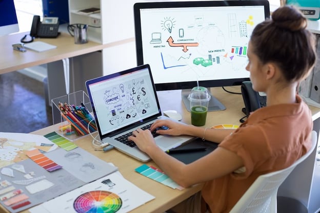 Digitization vs digitalization: designer working on a project using 2 computers
