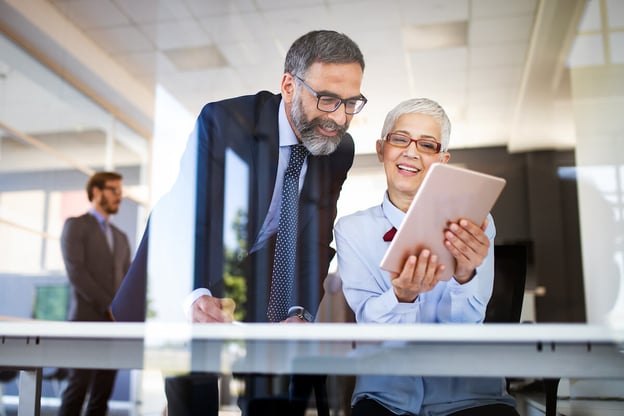 Intelligent process automation: two professionals looking at something on a tablet