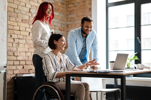 Human resources automation: employees working together using a laptop
