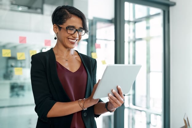 Manager happily using a tablet