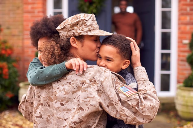 Soldier hugging her kids