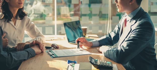 Insurance automation: couple talking to an insurance agent