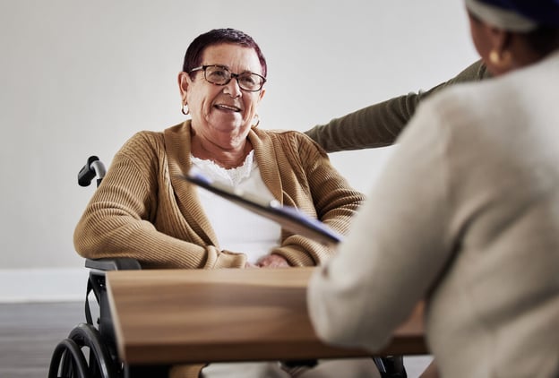 Workers comp case management: senior woman talking to a case manager