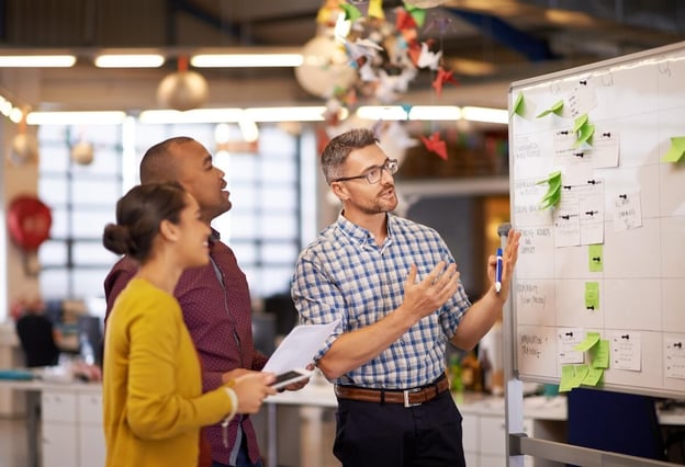 Work efficiency: employees looking at a whiteboard