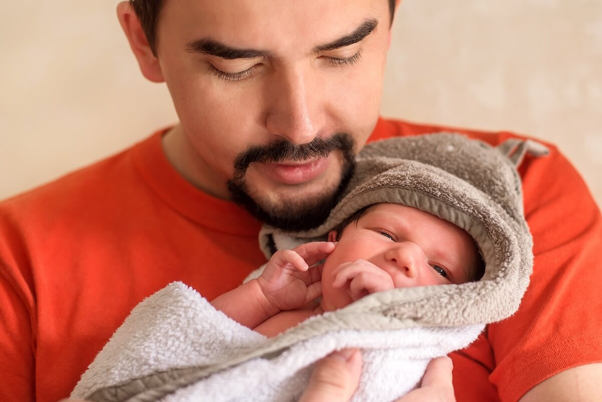 NICU leave: father carrying his baby