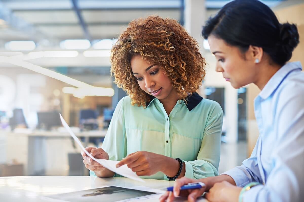 Manual HR processes: HR managers looking at a document