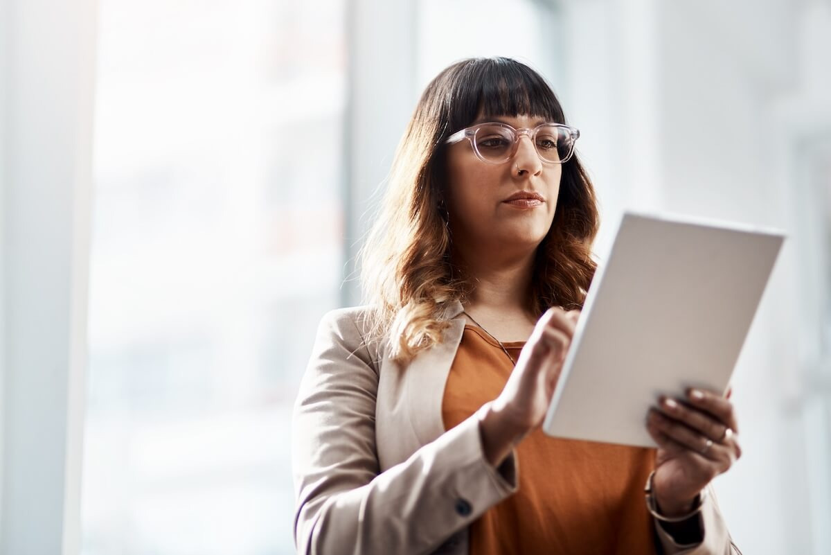 Employee wearing a pair of eyeglasses, using a tablet
