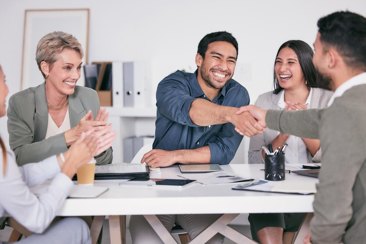 Colleagues shaking hands in a meeting