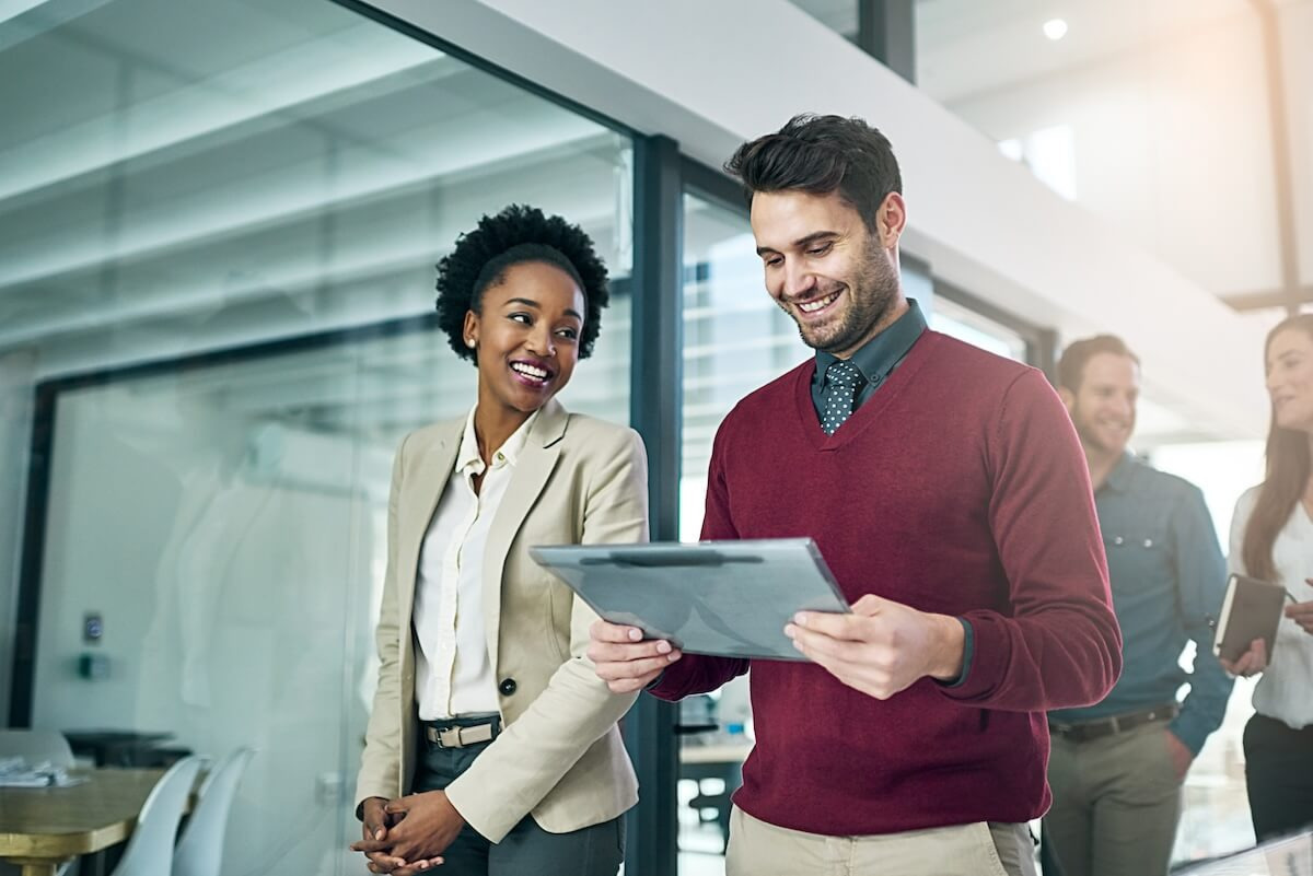 Employees talking while using a tablet