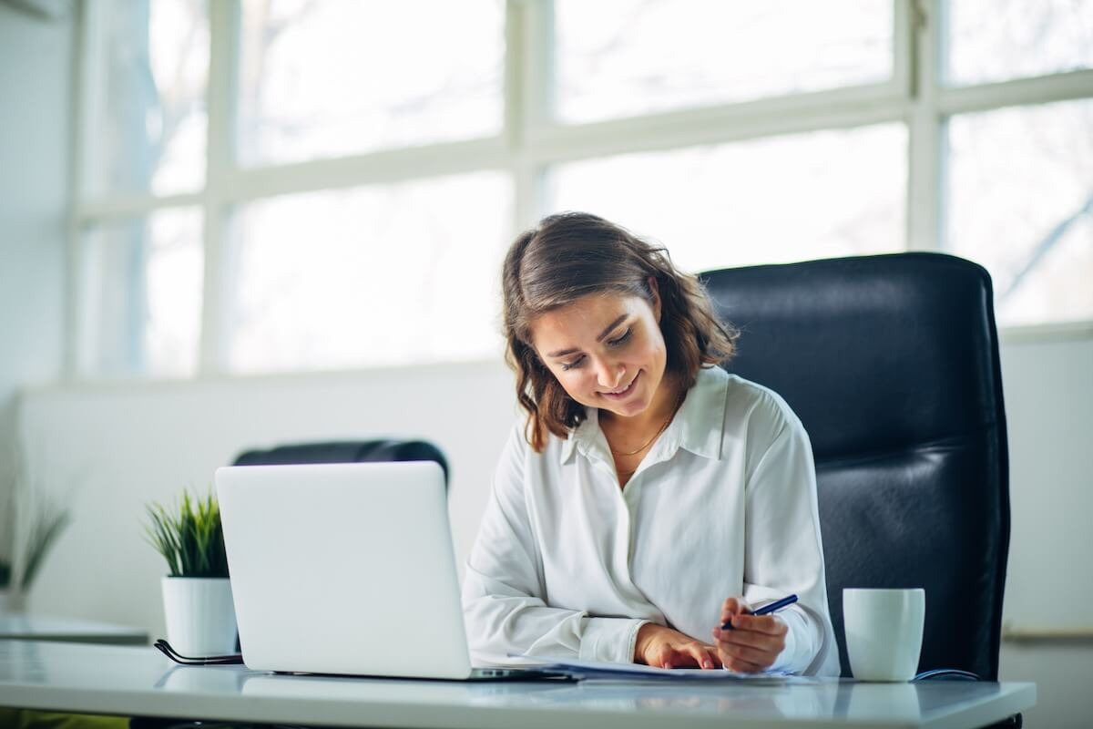 Building trust with employees: employee happily writing in a notebook