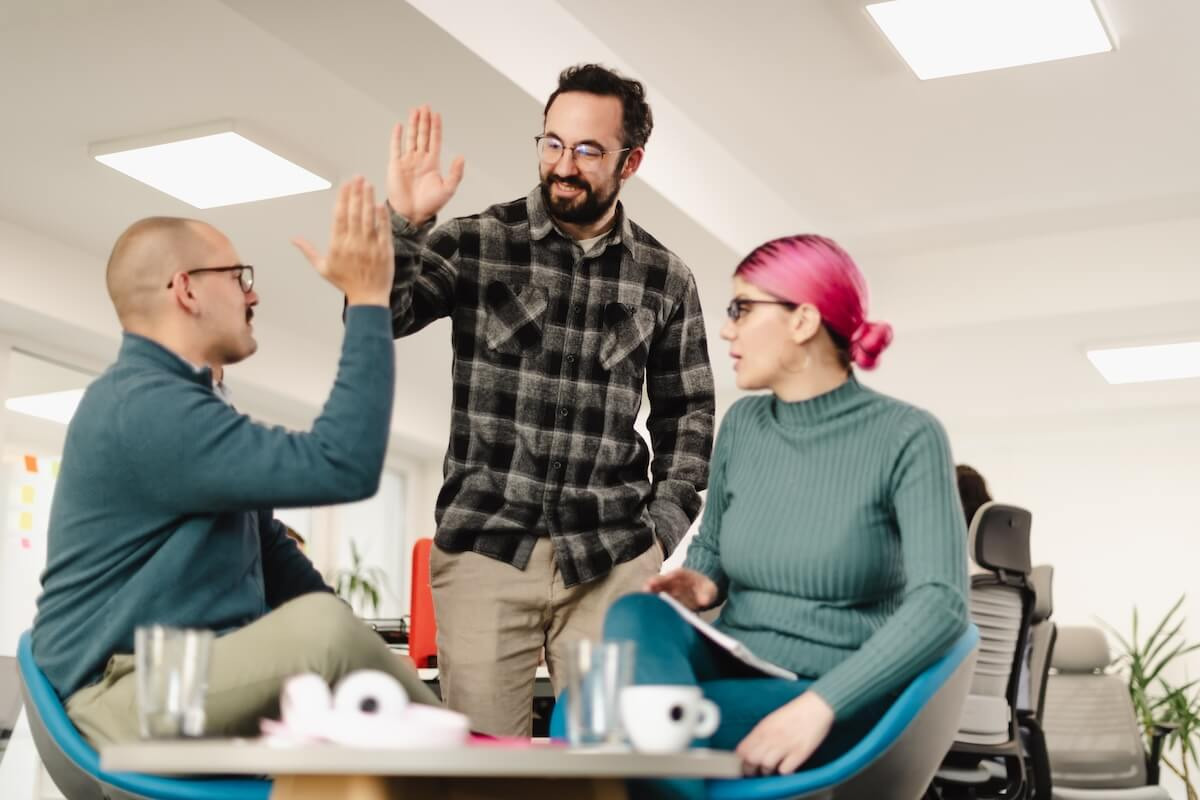 Employees giving each other a high five