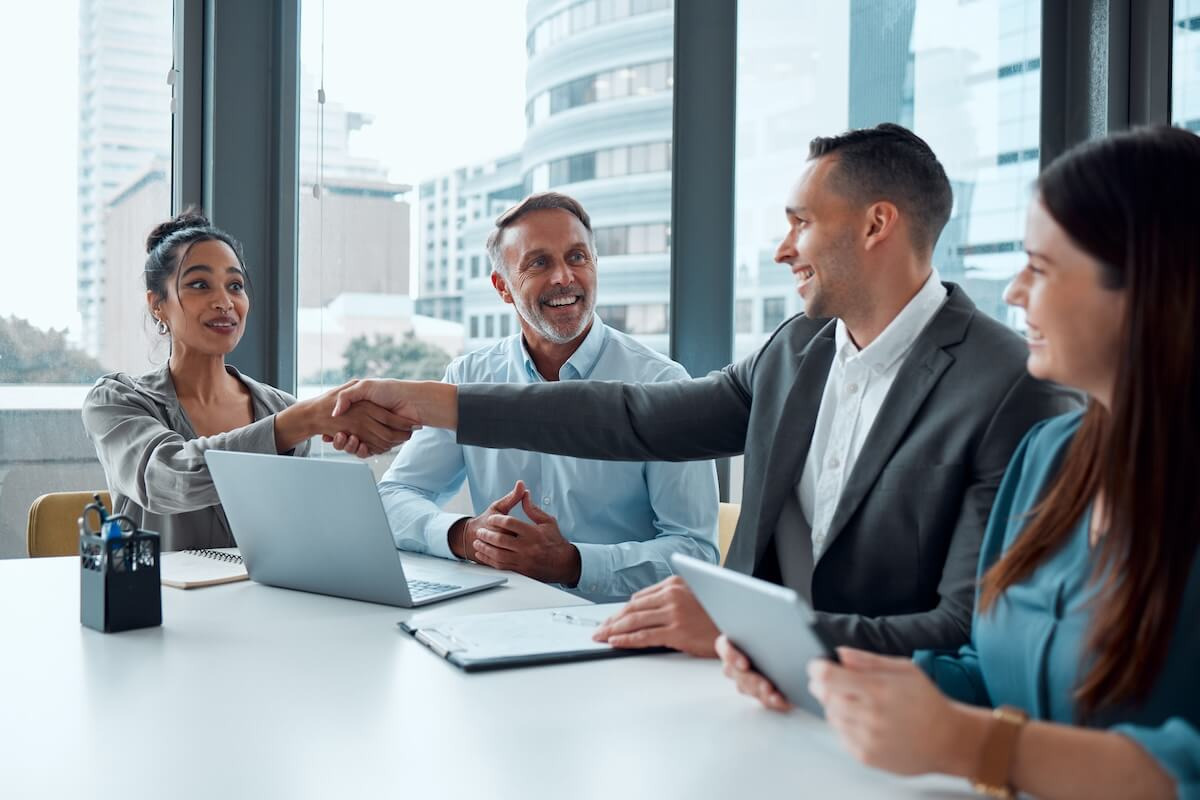 HR team shaking hands at a meeting