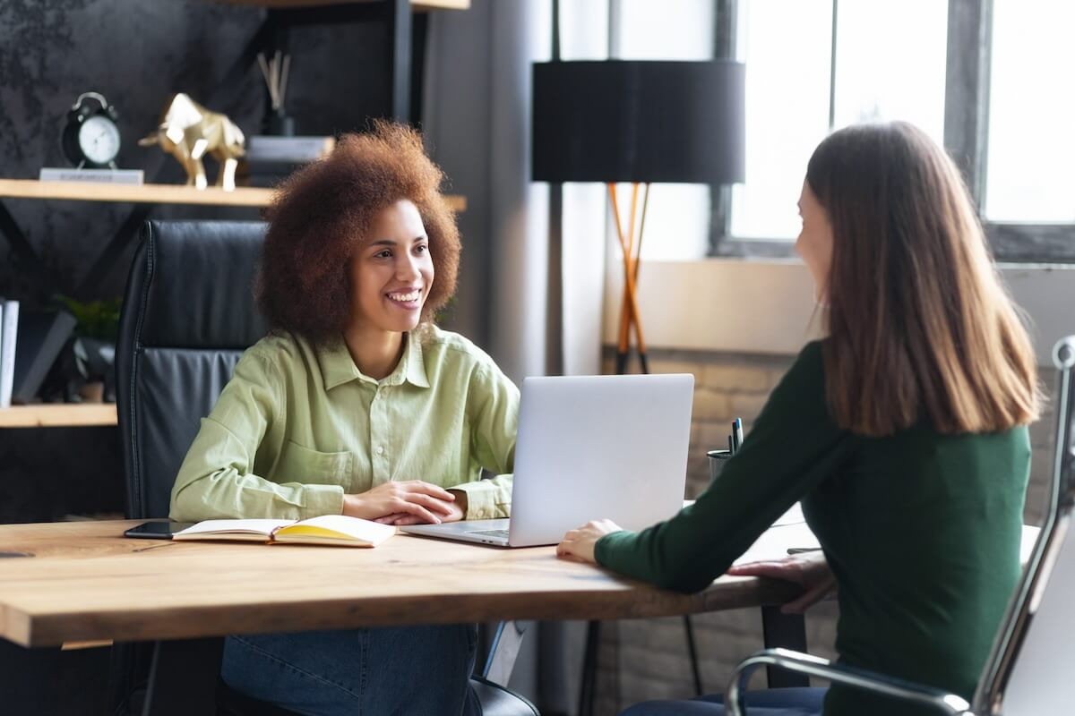 HRIS vs leave management software: HR director talking to an employee