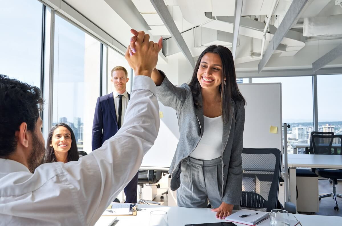Colleagues giving each other a high five