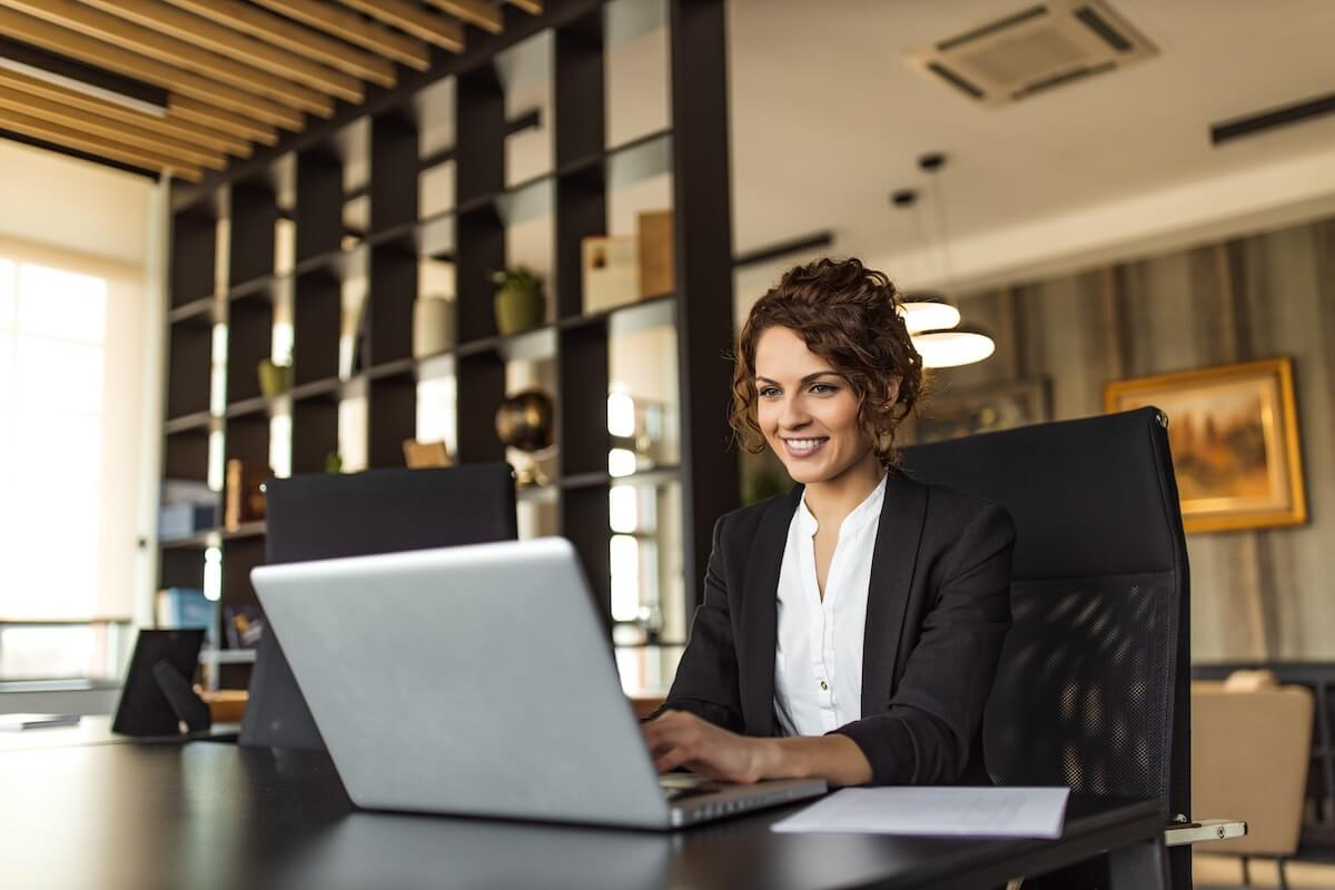 Manager happily using her laptop