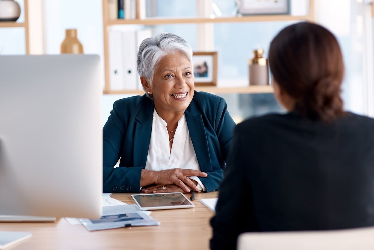 ROI of HR technology: senior HR manager talking to an employee