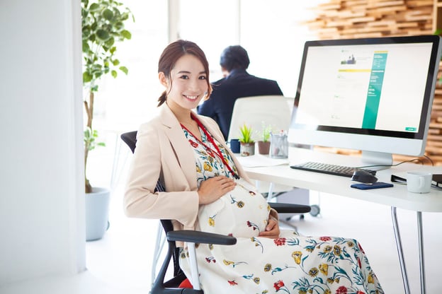 Pregnant woman at her office