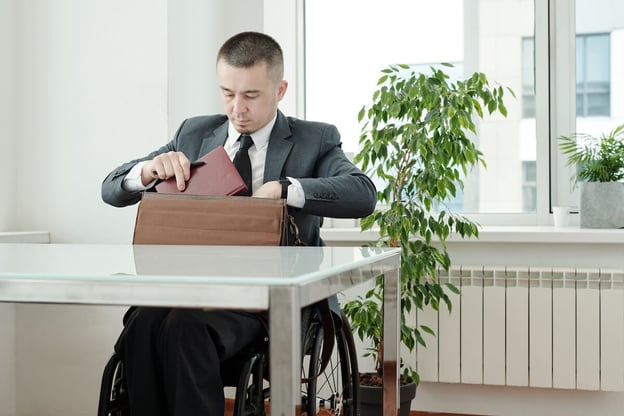 Intermittent FMLA: executive in a wheelchair putting things in his bag