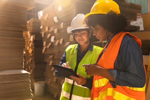 Two construction workers looking at tablet