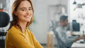 FMLA eligibility: employee smiling at the camera