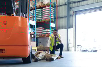 Risk management solutions: person calling for help for his injured co-worker