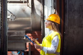 Inspection report template: engineer checking a machine