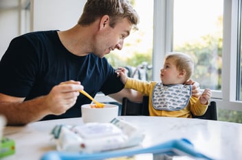 FMLA Massachusetts: father feeding his child