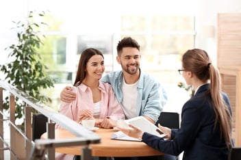 Insurance automation: happy couple talking to an agent