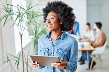 No code tools: happy entrepreneur holding a tablet