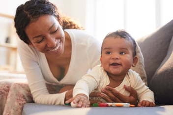 FMLA maternity leave: mother holding her child while on the couch