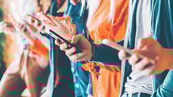 No code movement: a line of people using their smartphones