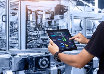 Automation step by step: person looking at charts and graphs from a tablet