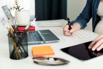 Leave management: person writing on a desk calendar