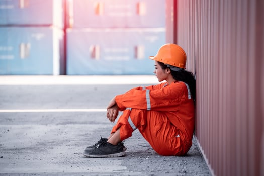 Absence management software: tired engineer sitting on the ground