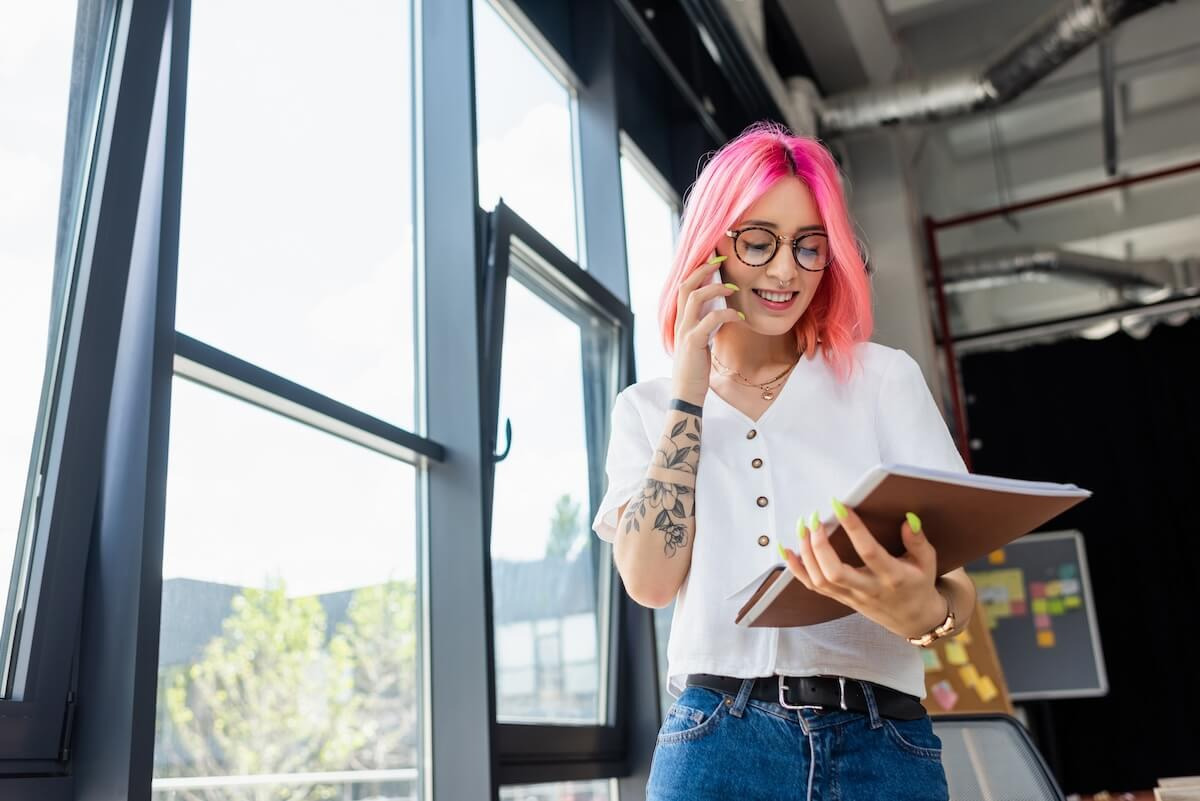 Employee talking on the phone and holding a notebook