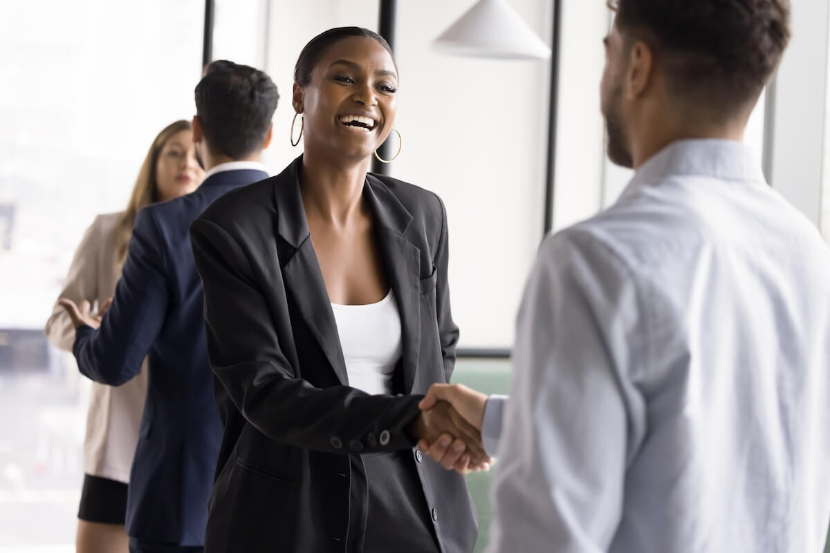Employee shaking hands with her colleague