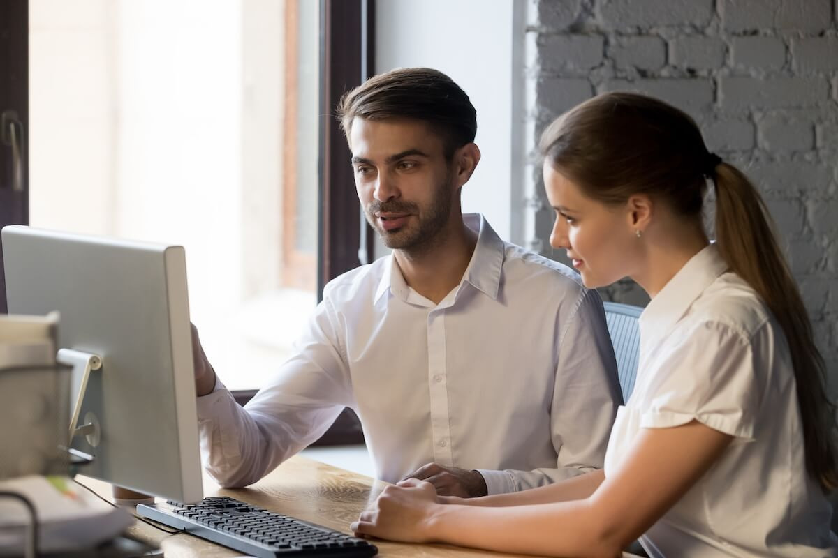 HR compliance software: employees looking at a computer