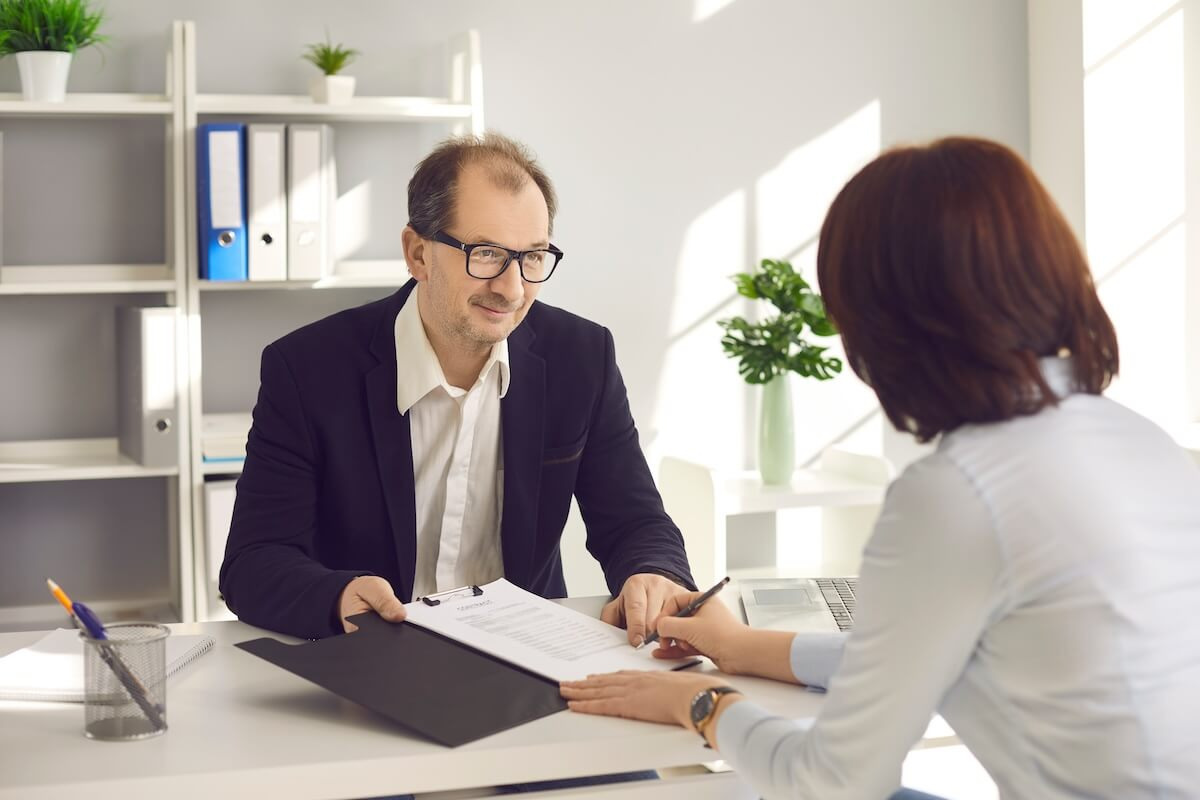Manager showing a contract to an employee
