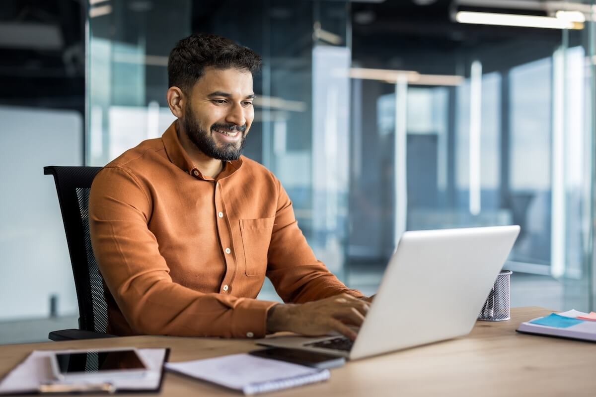 Team member uses laptop for HR tech onboarding