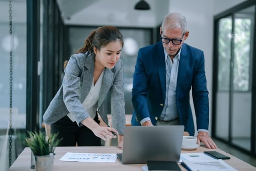 Leave of absence tracking softtware: entrepreneurs looking at a laptop