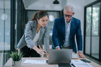 Leave of absence tracking softtware: entrepreneurs looking at a laptop